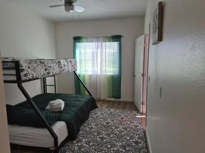 a bedroom with a bunk bed and a window at Amazing Guest House near Monserate Winery with 360 Mountain Views in Fallbrook