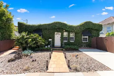 a house with a white door and a fence at La Dolce Vita by Coastline Vacation Rentals in San Diego