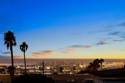 a view of a city at night with palm trees at La Dolce Vita by Coastline Vacation Rentals in San Diego