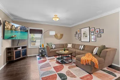 a living room with a couch and a table at La Dolce Vita by Coastline Vacation Rentals in San Diego