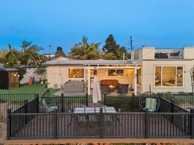 a house with a balcony with a table and chairs at The Lookout by Coastline Vacation Rentals in Chula Vista