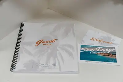 two notebooks sitting on top of a table at The Lookout by Coastline Vacation Rentals in Chula Vista