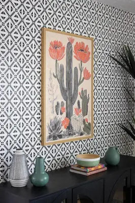 a painting of cacti on a wall next to a table at Casa del Sol by Coastline Vacation Rentals in San Diego