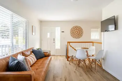 a living room with a couch and a table at Athena FULL Property in Encinitas