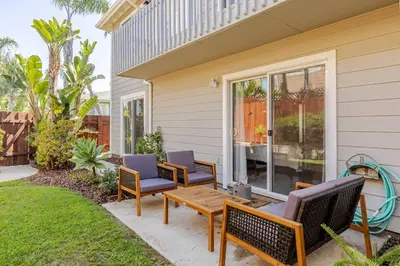 a patio with chairs and a table on a house at Athena FULL Property in Encinitas