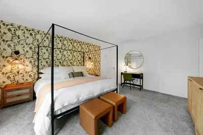 a bedroom with a canopy bed and a desk with a chair at Athena FULL Property in Encinitas