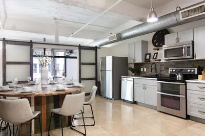a kitchen with a table and chairs in a room at SD Modern Rustic 3BR Apartment in San Diego