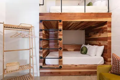 a bunk bed in a room with a ladder at SD Modern Rustic 3BR Apartment in San Diego