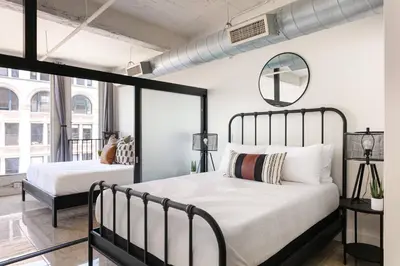 a bedroom with two beds and a mirror at SD Modern Rustic 3BR Apartment in San Diego