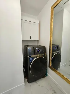 a washer and dryer in a bathroom with a mirror at Modern Marble Retreat Private Gated ADU with Laundry & Parking in National City