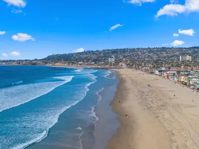an aerial view of a beach with people on it at The Sands by Coastline Vacation Rentals in San Diego