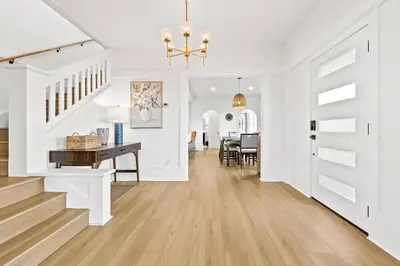a white hallway with a desk and a dining room at Vista Voltaire by Coastline Vacation Rentals in San Diego