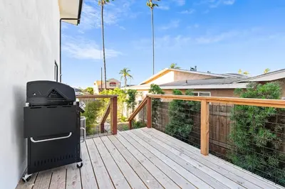 a bbq grill on a wooden deck at Vista Voltaire by Coastline Vacation Rentals in San Diego
