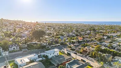 an aerial view of a city with houses and the ocean at Vista Voltaire by Coastline Vacation Rentals in San Diego