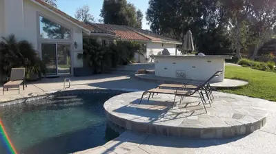 a pool with chairs and a table in a yard at Villa La Cresta - 5 Acre Retreat in Murrieta
