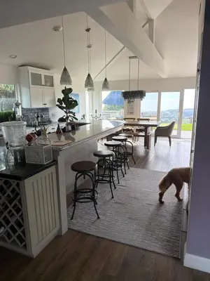 a kitchen with a dog standing in the middle of a room at Avenida Paradise! in San Clemente