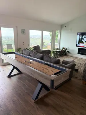 a living room with a large couch and a tv at Avenida Paradise! in San Clemente