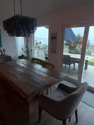 a dining room with a wooden table and chairs at Avenida Paradise! in San Clemente