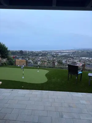 a golf course with a chair and golf balls on the grass at Avenida Paradise! in San Clemente
