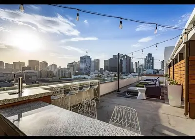 a rooftop bar with chairs and a view of the city at Spacious 3bed Apt with pool close to SDCC in San Diego