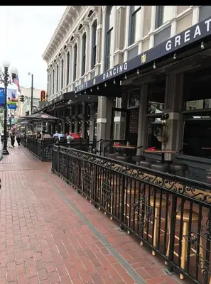 a building on a city street with a fence at Spacious 3bed Apt with pool close to SDCC in San Diego