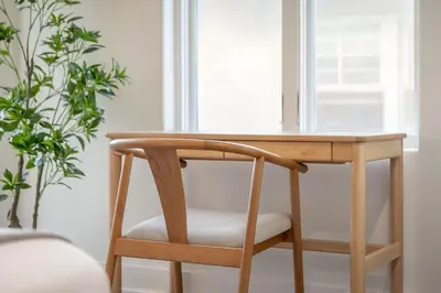 a wooden desk with a chair next to a window at Sea & Sand - Ocean View La Jolla Condo in San Diego