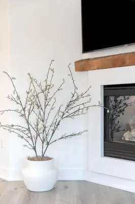 a white fireplace with a plant in a white vase at Sea & Sand - Ocean View La Jolla Condo in San Diego