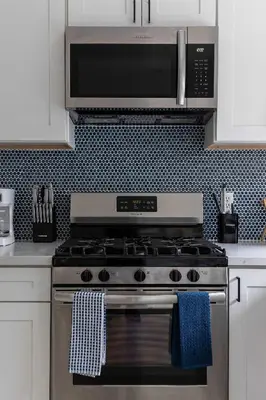 a kitchen with a stainless steel stove with a microwave at Close to Balboa Park Central Villa in San Diego