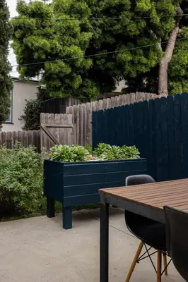 a blue planter with plants in it next to a fence at Close to Balboa Park Central Villa in San Diego
