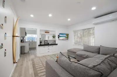 a living room with a couch and a kitchen at Close to Balboa Park Central Villa in San Diego