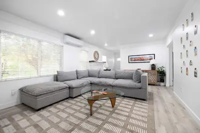 a living room with a couch and a table at Close to Balboa Park Central Villa in San Diego