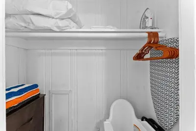 a small bathroom with a sink and a shelf at The Ruby Door by Coastline Vacation Rentals in San Diego