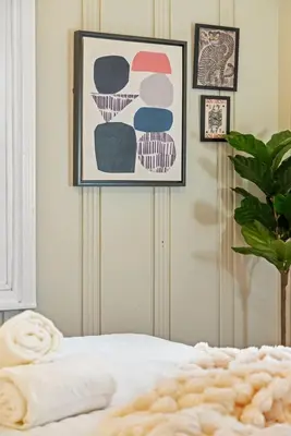 a bedroom with a bed and a painting on the wall at The Ruby Door by Coastline Vacation Rentals in San Diego