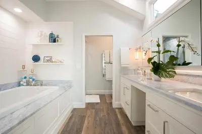a white bathroom with a tub and a sink at Newport Beach Oceanfront Home in Newport Beach