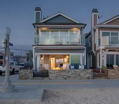 a house with a porch with chairs on a street at Newport Beach Oceanfront Home in Newport Beach
