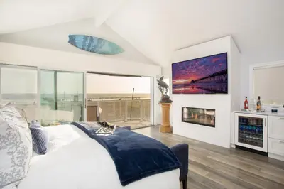 a bedroom with a bed and a large window at Newport Beach Oceanfront Home in Newport Beach