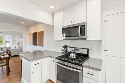 a white kitchen with a stove and a microwave at Cliff View - Prime Downtown La Jolla in San Diego