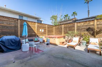 a patio with chairs and a table and an umbrella at Ocean Beach Bungalow - Close To Beach in San Diego