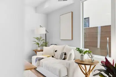 a white living room with a white couch at Elevated Coastal Living | Rooftop Deck Steps from Beach & Restaurants in San Diego