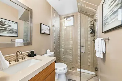 a bathroom with a sink and a toilet and a shower at Elevated Coastal Living | Rooftop Deck Steps from Beach & Restaurants in San Diego