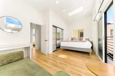 a white bedroom with a bed and a table at PB New Build - Steps to Sand & Surf in San Diego