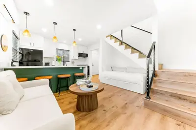 a living room with a white couch and a table at PB NEW BUILD l A Block from SAND in San Diego