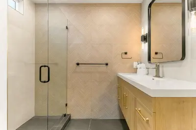 a bathroom with a shower with a sink and a mirror at PB NEW BUILD l A Block from SAND in San Diego
