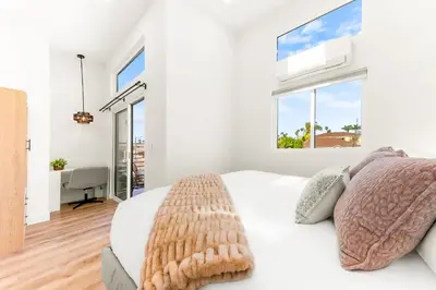 a white bedroom with a bed and a window at PB NEW BUILD l A Block from SAND in San Diego