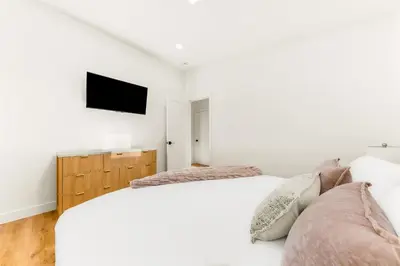 a bedroom with two beds and a tv on the wall at PB NEW BUILD l A Block from SAND in San Diego