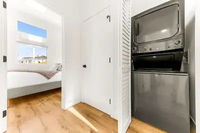 a bedroom with a bed and a tv in a closet at PB NEW BUILD l A Block from SAND in San Diego