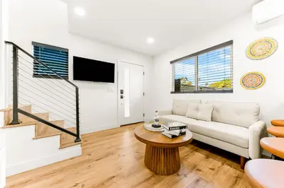 a living room with a couch and a table at PB NEW BUILD l A Block from SAND in San Diego