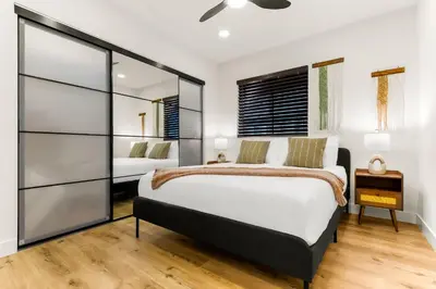 a bedroom with a large bed and a window at PB Beach Compound - 2 New Homes Steps to Sand in San Diego