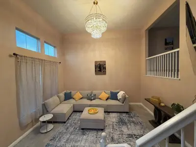 a living room with a couch and a chandelier at Private and Stylish 3Bdrm 3Ba Townhome, Gated Patio, King Bed, spacious in National City