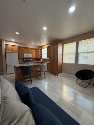 a living room with a couch and a kitchen at Private and Stylish 3Bdrm 3Ba Townhome, Gated Patio, King Bed, spacious in National City